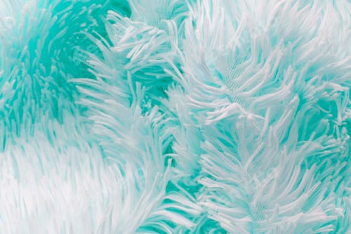 Preview: delicate soft background of plush fabric folds on white background. Copy space.