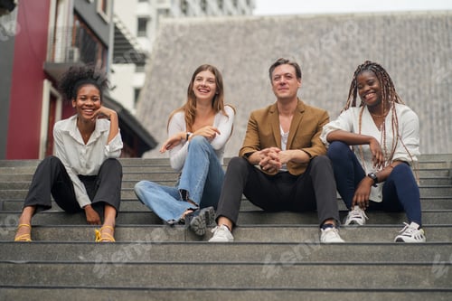 Preview: Happy Young Friends Sitting on Outdoor Steps Together