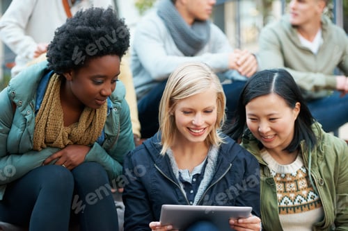 Preview: Look at this. Shot of a group of university students looking at something on a digital tablet.