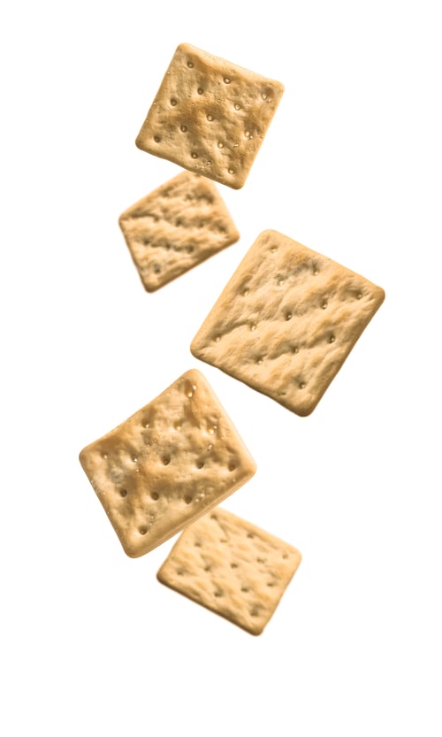Preview: Flying group of dry crackers isolated on white background with shadow