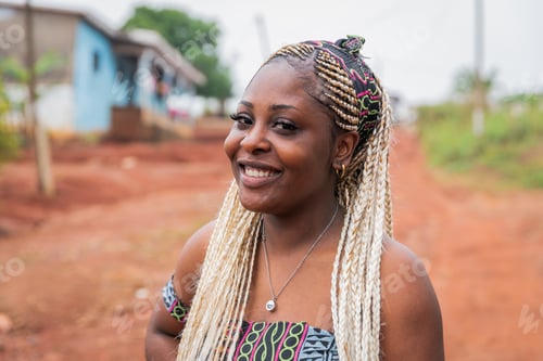 Preview: Portrait of a smiling African girl with braids and traditional clothes