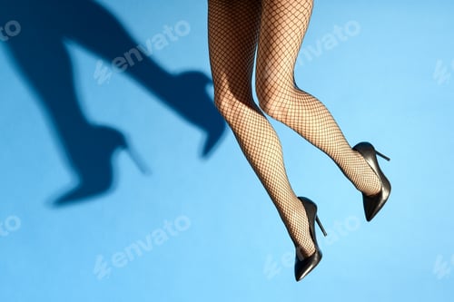Preview: Falling legs of a woman wearing sexy black fishnets and stiletto