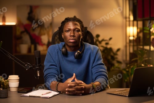 Preview: Portrait of African American Podcaster Sitting at Desk