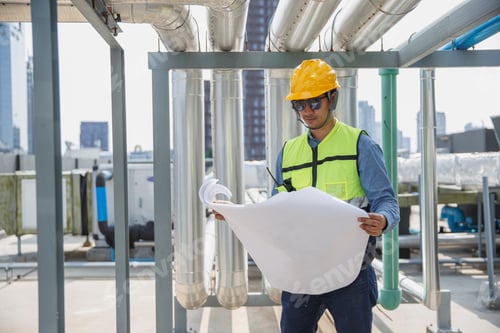 Preview: Male operator worker reading blueprint checking drawing plan cooling air piping HVAC