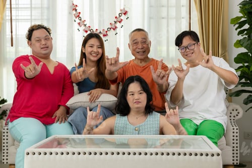 Preview: A family of autistic children are having fun playing board games together by the Christmas tree.