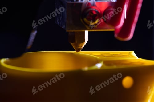 Preview: 3D printer printing a part made of yellow plastic, close-up view