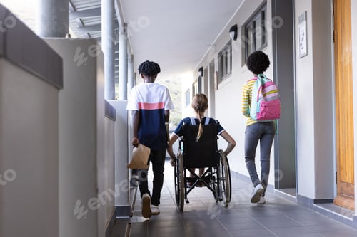 Preview: Walking in school hallway, diverse students with backpacks and wheelchair, heading to class