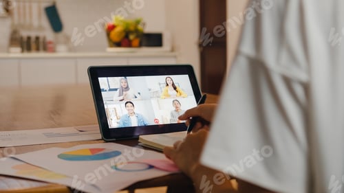 Preview: Asia businesswoman using digital tablet talk to colleague about plan by video call meeting