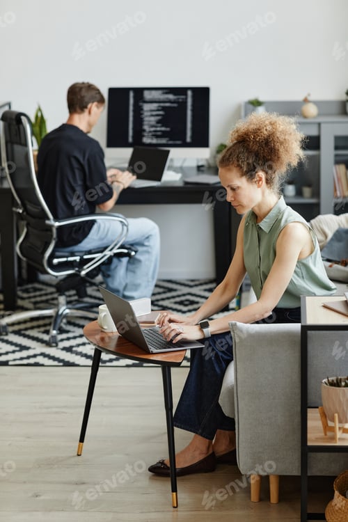 Preview: Programmers working together at office