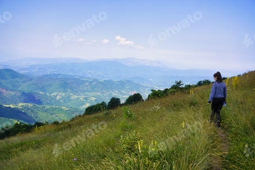 Preview: A young women on a top of the mountain