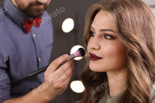 Preview: Professional makeup artist working with client in dressing room