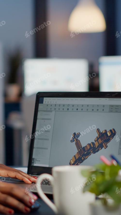 Preview: Black woman architect working in modern cad program at laptop