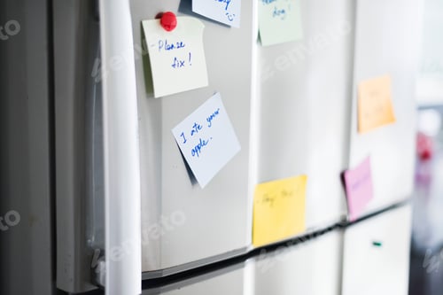 Preview: Closeup of reminder paper note on fridge door