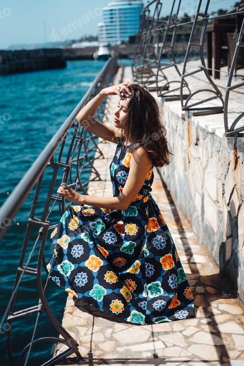 Preview: Young pretty woman on the pier near