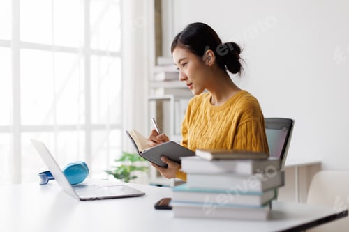 Preview: Asian woman student studying online holding notebook
