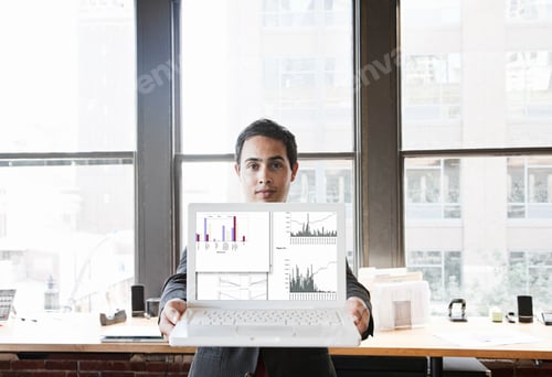 Preview: Hispanic man with his laptop at his office workstation.