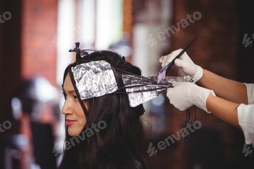 Preview: Hairdresser dyeing hair of her client