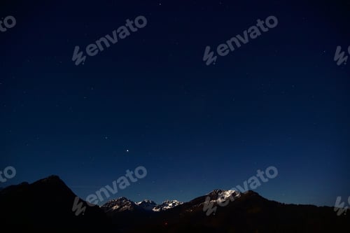 Preview: Majestic night scene in the Allgaeu Alps with the snow-capped summit and a mountain range