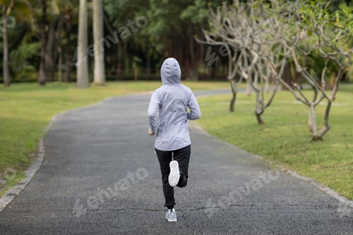 Preview: Healthy lifestyle sporty asian woman running at tropical park