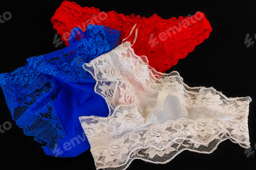 Preview: Closeup shot of blue, white, and red lingerie isolated on a black background