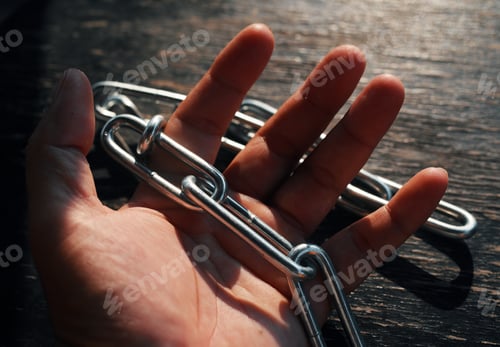 Preview: Close-up view of a hand holding the iron chain