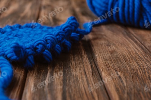 Preview: close up view of blue yarn for knitting on wooden surface