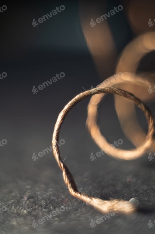 Preview: Shallow focus shot of a copper wire on the rough surface