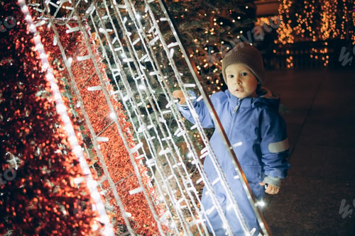 Preview: portrait of a child in a blue jumpsuit at the Christmas market in Zagreb