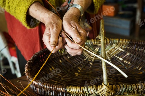 Preview: Close up of woman weaving a basket in weaver's workshop.