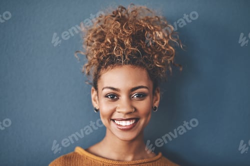 Preview: Smiling Woman with Curly Hair Poses Confidently