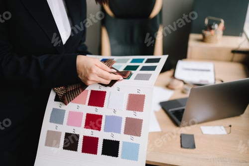 Preview: Designer evaluates swatches, comparing colors and textures for apparel selection.