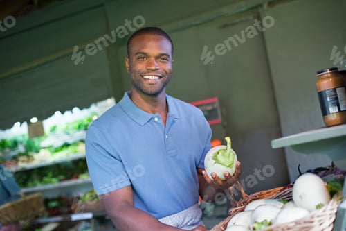Preview: An organic fruit and vegetable farm. A man sorting vegetables.