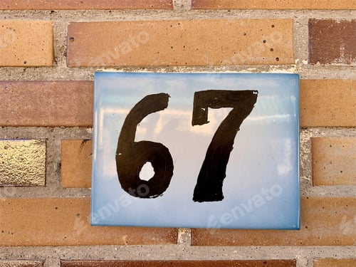Preview: Closeup shot of number 67 in the address on the building wall