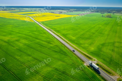 Preview: Moving cars on a road between green fields in Poland