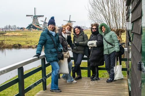 Preview: Cheerful mature women friends traveling together in zaanse schans