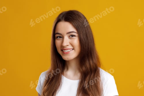 Smiling Young Woman Portrait on Yellow Background
