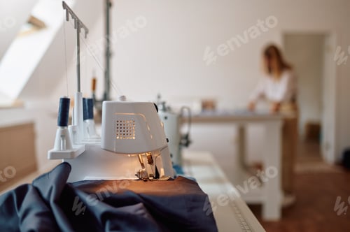 Preview: Sewing machine, seamstress works at the table