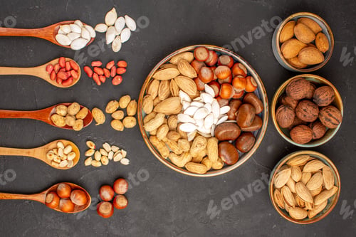 Preview: top view nut composition different nuts on dark background walnut many snack nut