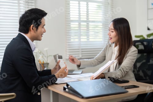 Preview: Professional meeting between financial advisor and client discussing investment strategies.