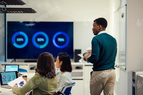Preview: Rear view of an african american man boss walking in a boardroom