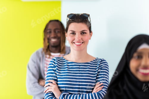 Preview: Diverse teenagers using mobile devices while posing for a studio photo in front of a colorful
