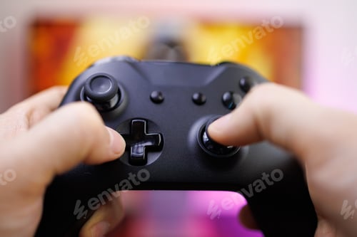 Preview: A close-up of the game controller's control buttons. Video game gamepad in hand