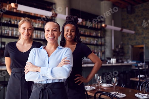 Preview: Portrait Of Female Owner Of Restaurant Bar With Team Of Waiting Staff Standing By Counter