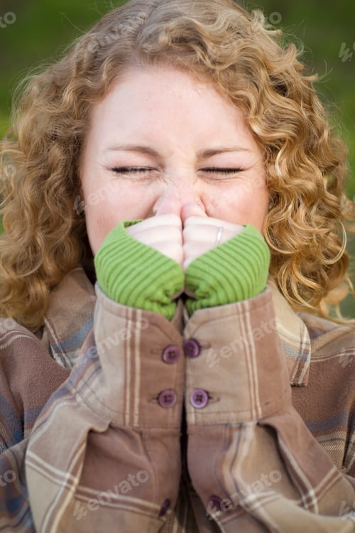 Preview: Pretty Young Woman Sneezing Outdoors.