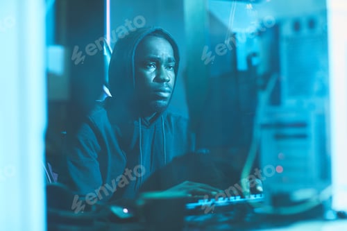 Preview: Tired black man typing on computer