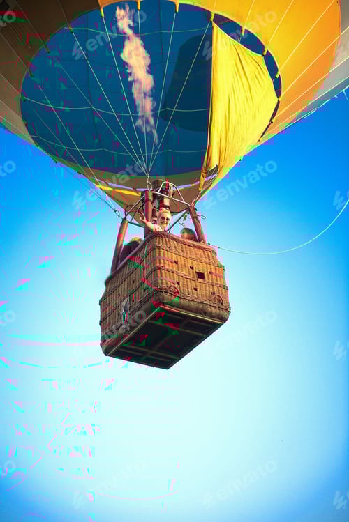 Preview: A group of smiling happy people in a balloon basket on a background of clear blue sky