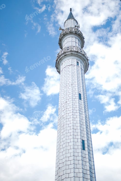Preview: Vertical low angle shot of a minaret on a cloudy sky background