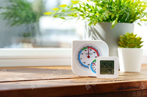 Preview: Digital Thermometer Displaying Temperature and Humidity Near Window