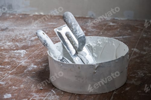 Preview: Applying decorative putty. White abstract texture of surface covered with putty