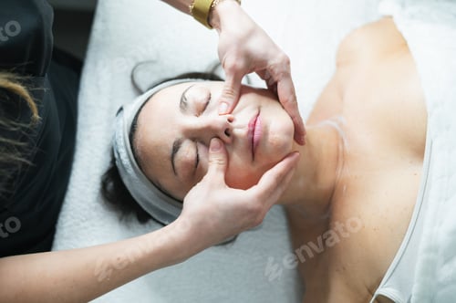 Preview: Woman enjoying relaxing facial massage at spa